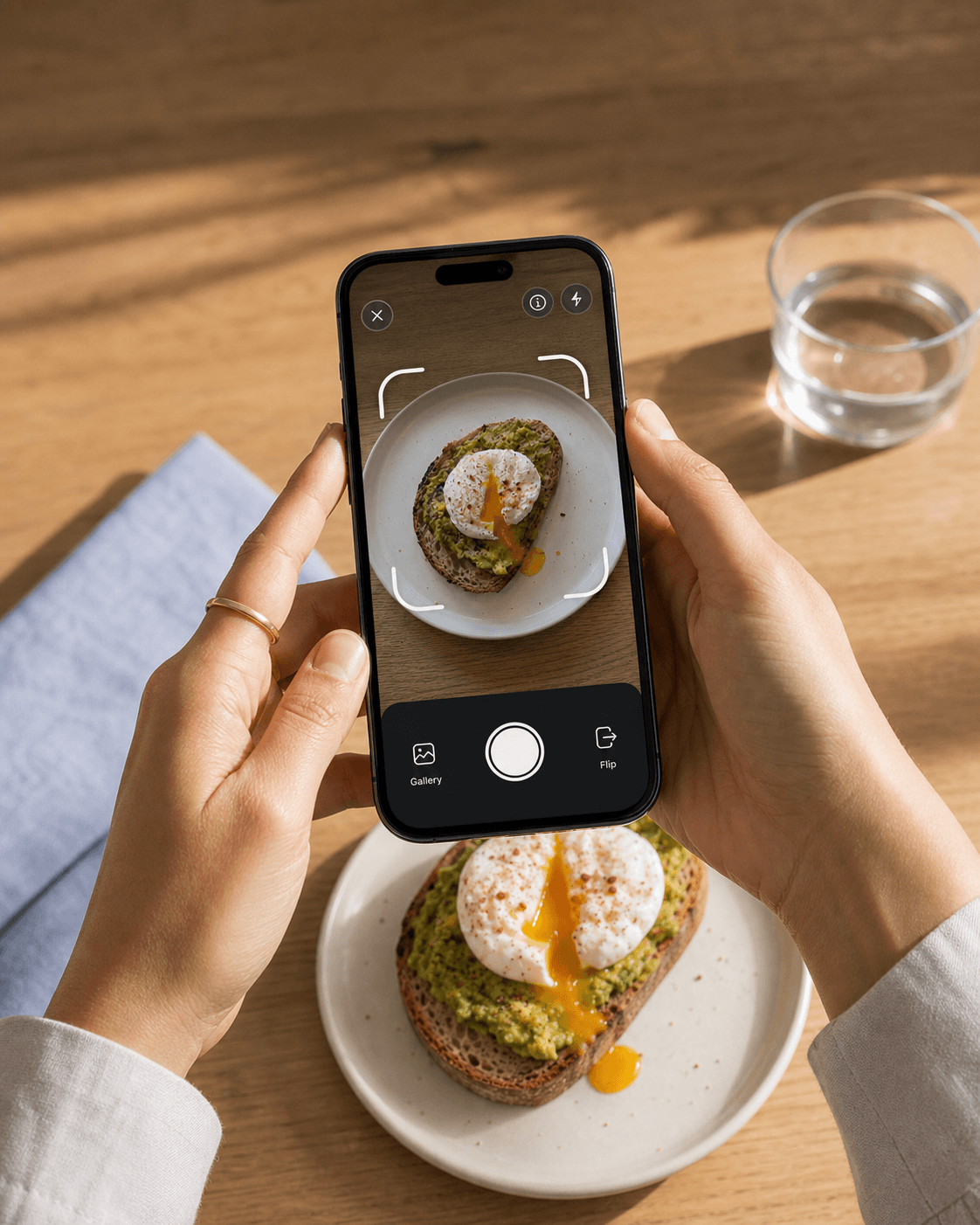 A person photographing avocado toast with the Bitsy camera